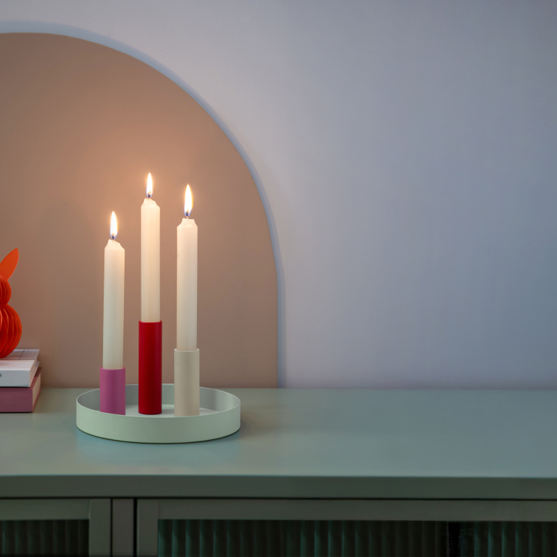 Luna Mini Kerzenhalter rund von REMEMBER auf dem Sideboard – 3 farbige, magnetische Kerzenhalter im Tablett mit brennenden Stabkerzen in moderner Wohnszene.
