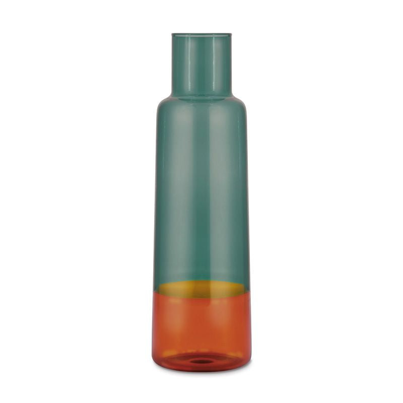 Freigestellte Glaskaraffe von REMEMBER in multicolor Optik mit grünlich-transparentem Oberteil und warm orangefarbenem Unterteil vor weissem Hintergrund.